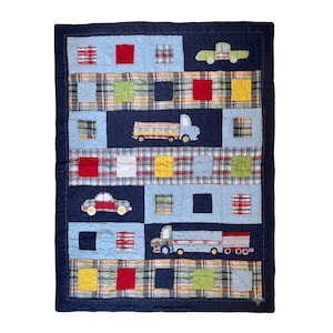 May include: A rectangular patchwork quilt featuring a dark navy blue border and a repeating pattern of light blue and plaid fabric squares. The design includes appliqued fabric vehicles, specifically cars and trucks, in various colors and textures.