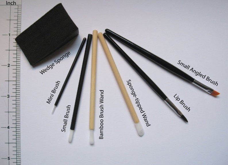May include: A set of seven makeup brushes and applicators, including a wedge sponge, mini brush, small brush, bamboo brush wand, sponge-tipped wand, small angled brush, and lip brush.