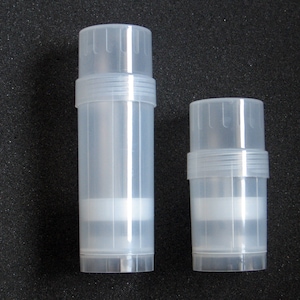 May include: Two clear plastic containers with a screw-on lid. The containers are cylindrical and have a smooth, shiny surface. The larger container is about 10 cm tall and the smaller container is about 7 cm tall.