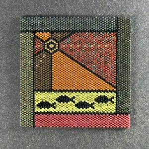 May include: Square beaded artwork with an abstract design. The artwork features a geometric pattern with orange, red, yellow, and black elements. The border is a dark green color, and the piece has a textured appearance.