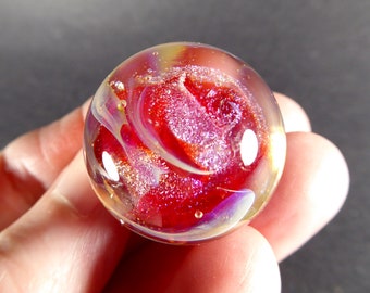 Glowing cardinal red transparent lampwork glass marble with swirls of sparkling purple dichro #569
