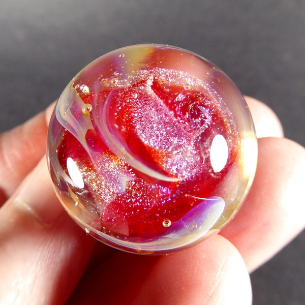 Glowing cardinal red transparent lampwork glass marble with swirls of sparkling purple dichro #569