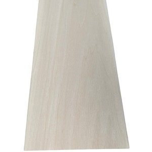 May include: A sheet of light wood veneer with a smooth, natural grain pattern.