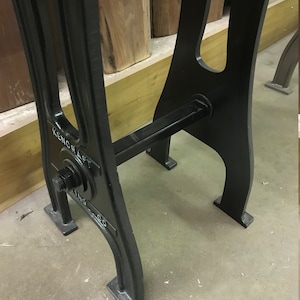 May include: Black metal table legs with a crossbar and a round metal plate with the text "KENCRAFT" on it.