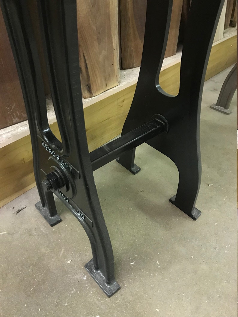 May include: Black metal table legs with a crossbar and a round metal plate with the text "KENCRAFT" on it.