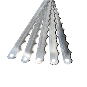 May include: Five silver serrated blades for a bread slicing machine. The blades are arranged in a fan shape, with the tips pointing towards the right side of the image.