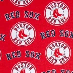 May include: Red fabric with a repeating pattern of white circles with the words "Boston Red Sox" and a red sock logo. The background is red.