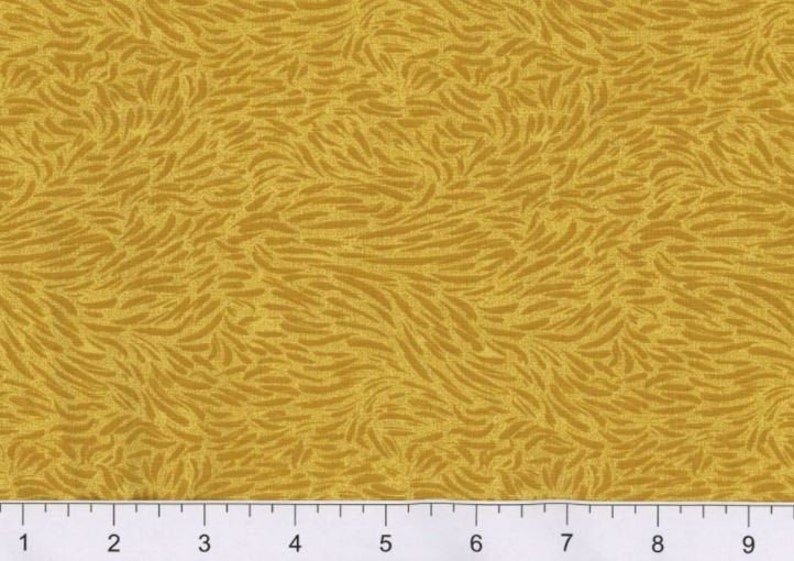 May include: A yellow fabric with a subtle, swirling pattern of brown lines. The fabric has a textured surface.