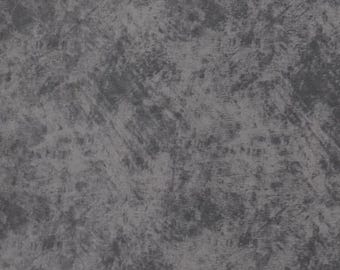 May include: A fabric surface featuring a mottled, distressed pattern in shades of charcoal gray and slate gray. The texture appears uneven with darker, irregular patches layered over a lighter gray base, creating a weathered, stone-like visual effect.