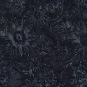 May include: Dark blue fabric with a floral pattern. The design features various flower shapes and leafy elements in shades of blue and gray, creating a textured, artistic look. The fabric has a batik-like appearance.