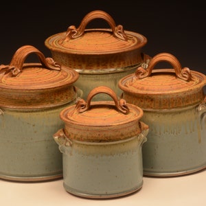 This four piece stoneware canister set ranges in size from 7" to 11" in height.