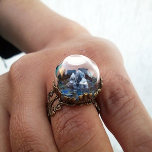 Miniature, highly detailed three dimensional landscape in a real glass dome, adjustable brass ring.