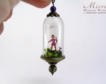 Miniature world pendant - A little girl is holding a real dandelion while running through a field of grass and colorful flowers.