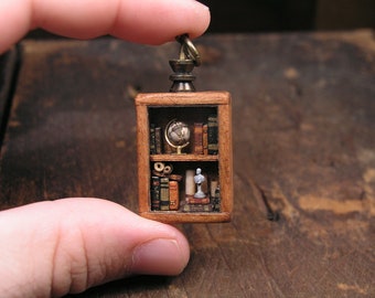 Miniature library pendant, full of tiny books, parchments, a globe and a bust