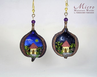 Miniature world earring in a kurajong seed. Tiny little house in green forest under the night and day sky