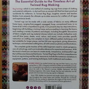May include: The Essential Guide to the Timeless Art of Twined Rug Making book cover features a photo of Bobbie Irwin, a rug maker, and a close-up of the book's spine with the title and author's name. The book cover is a light blue with white text.