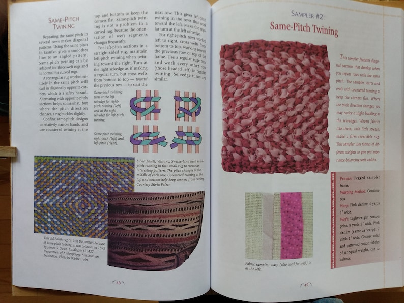 May include: A close-up of a book page showing a sample of a woven rug made with a technique called "same-pitch twining". The rug is made with pink and white fabric strips and has a slightly textured surface. The text on the page describes the technique and the materials used to create the rug.