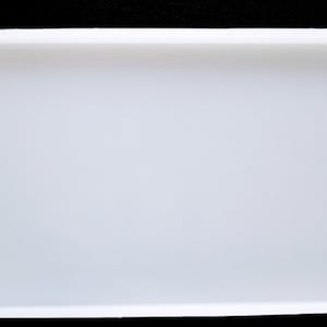 May include: A white rectangular silicone mold for resin casting.