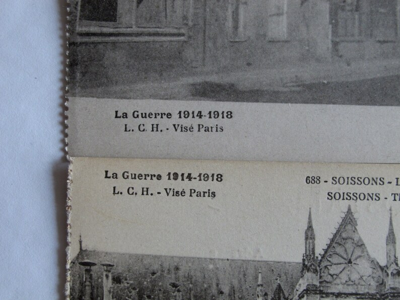May include: A black and white photograph of a building with a text overlay that reads "La Guerre 1914-1918 L. C. H. - Vis&eacute; Paris 688 - SOISSONS - L SOISSONS - T"