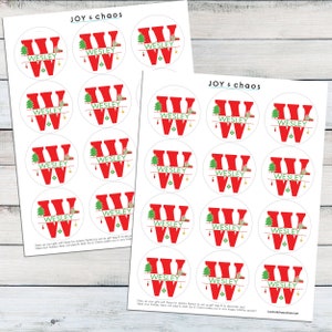May include: Printable sheet of 18 round Christmas gift tags featuring a red letter W with a green Christmas tree and presents. The name "Wesley" is printed on each tag.