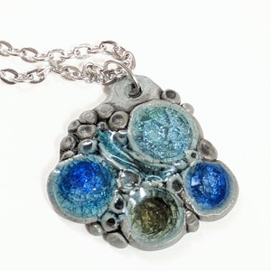 Te Moroiti Kikorangi- Porcelain pendant necklace with melted blue glass  (18 in silver chain).