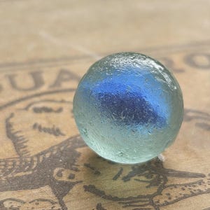 Blue cats eye sea glass marble from Scotland, surf tumbled and frosty, collectable beach glass