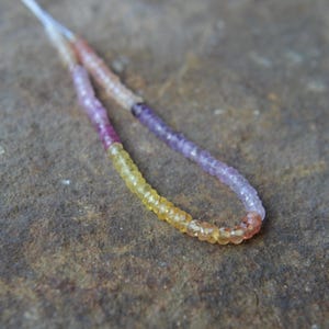 May include: A set of three ceramic mugs with a speckled, matte finish. The mugs are in shades of cream, light gray, and dark gray. Each mug has a simple, minimalist design and a rounded handle.