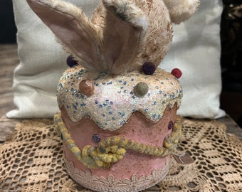 Raggedy junction primitive Easter Bunny diving into a cake