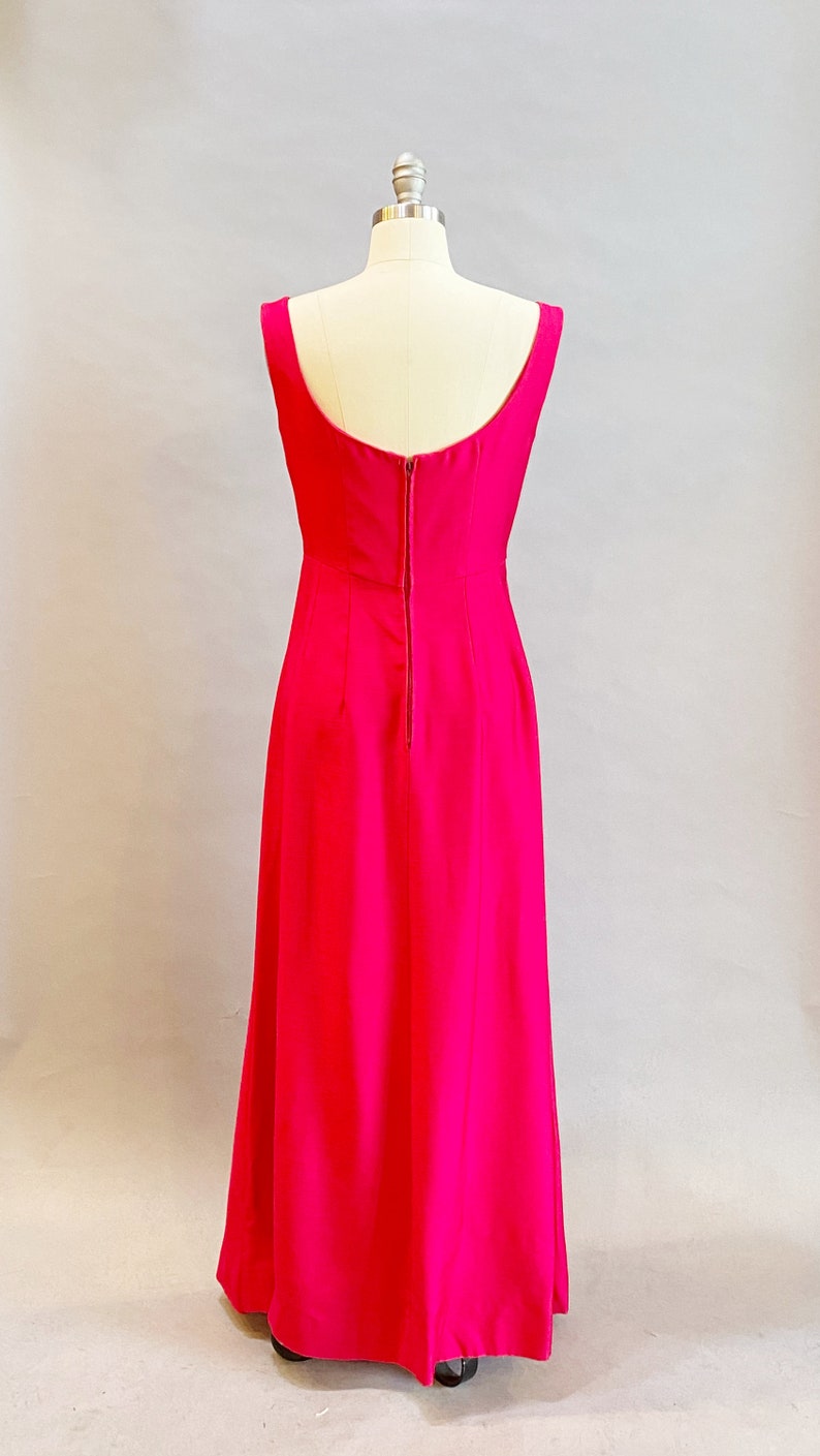 May include: A long, sleeveless, fuchsia pink dress with a back zipper closure.
