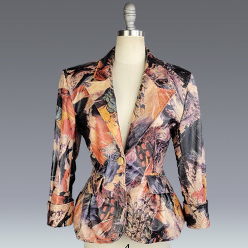 May include: A colorful patterned blazer with a fitted waist and long sleeves. The blazer has a button closure and a unique abstract print.