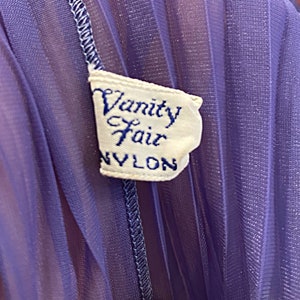 May include: A purple nylon fabric with a white label that reads "Vanity Fair NYLON".