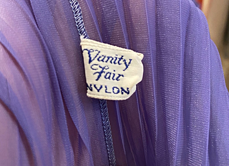 May include: A purple nylon fabric with a white label that reads "Vanity Fair NYLON".