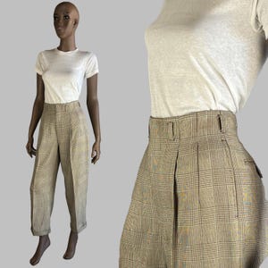 May include: High-waisted plaid pants with a brown, beige, and white pattern. The pants have a wide leg and are cuffed at the bottom.