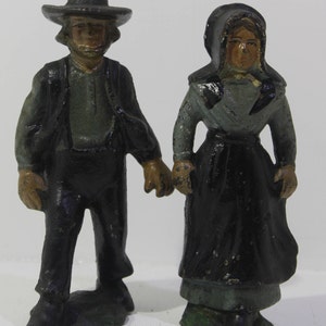 Vintage cast iron Amish man and woman