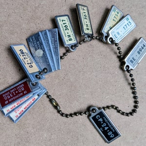 lot of (11) Disabled Veterans Postage guaranteed miniature keychain license plates