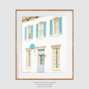 May include: A white building with blue shutters and a blue door. The building has a sign that says "14700 Easton".