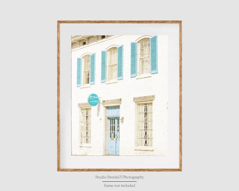 May include: A white building with blue shutters and a blue door. The building has a sign that says "14700 Easton".