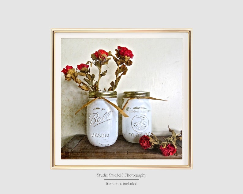May include: Two white painted mason jars with red dried flowers, one jar says "Ball Mason" and the other says "Golden Harvest Mason"