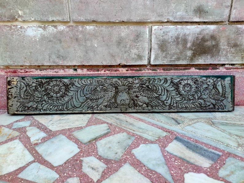 May include: A carved wooden panel with intricate floral and bird designs. The panel is painted in a dark green color and has a distressed finish.