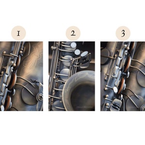 May include: Close-up of a silver saxophone with black keys and a brown leather strap. The saxophone is decorated with a silver design.
