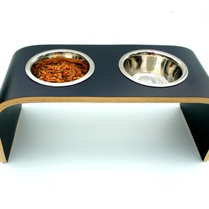 Top and front view of Black shell  ( matt finish ) double raised dog feeder with stainless steel bowls and natural wood edge finish.