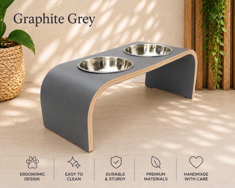 Graphite grey raised wooden dog bowl stand with stainless steel bowls, modern elevated pet feeder in a bright contemporary home, handmade dog and cat feeding station.