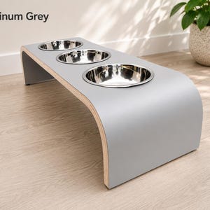 Modern platinum grey raised triple dog bowl stand with stainless steel bowls, handcrafted curved wooden pet feeder for dogs and cats.
