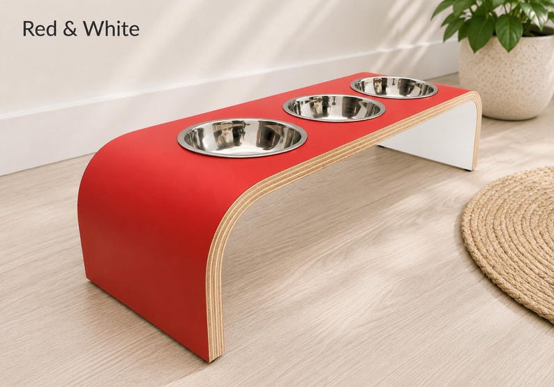 Modern red and white raised triple dog bowl stand with stainless steel bowls, handcrafted curved wooden pet feeder for dogs and cats.