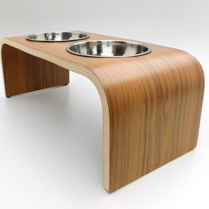 Angled view of Walnut double raised pet feeder with stainless steel bowls and natural wood edge finish.