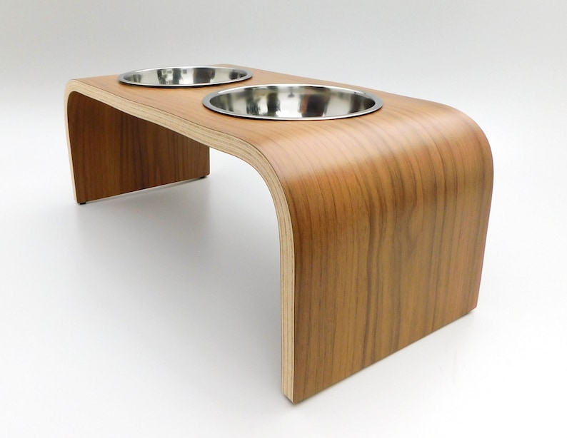 Angled view of Walnut double raised pet feeder with stainless steel bowls and natural wood edge finish.