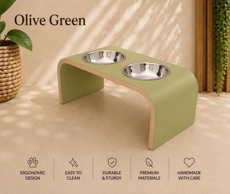 Olive green raised wooden dog bowl stand with stainless steel bowls, handmade elevated pet feeder in a contemporary home, stylish feeding station for dogs and cats.