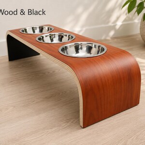 Modern cherry wood raised triple dog bowl stand with stainless steel bowls, handcrafted curved wooden pet feeder for dogs and cats.