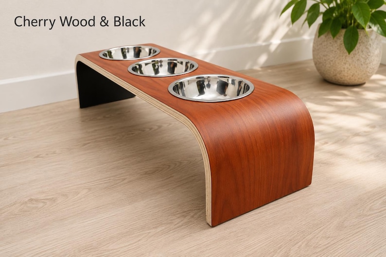 Modern cherry wood raised triple dog bowl stand with stainless steel bowls, handcrafted curved wooden pet feeder for dogs and cats.