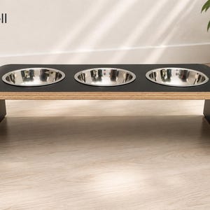 Modern black shell raised triple dog bowl stand with stainless steel bowls, handcrafted curved wooden pet feeder for dogs and cats.